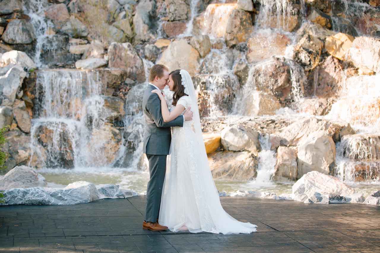 Wedding couple dances in front of the waterfall at Millennial Falls.
