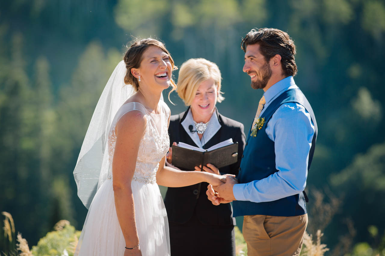 Bride laughs during ring exchange at her Alpine Meadows ceremony.