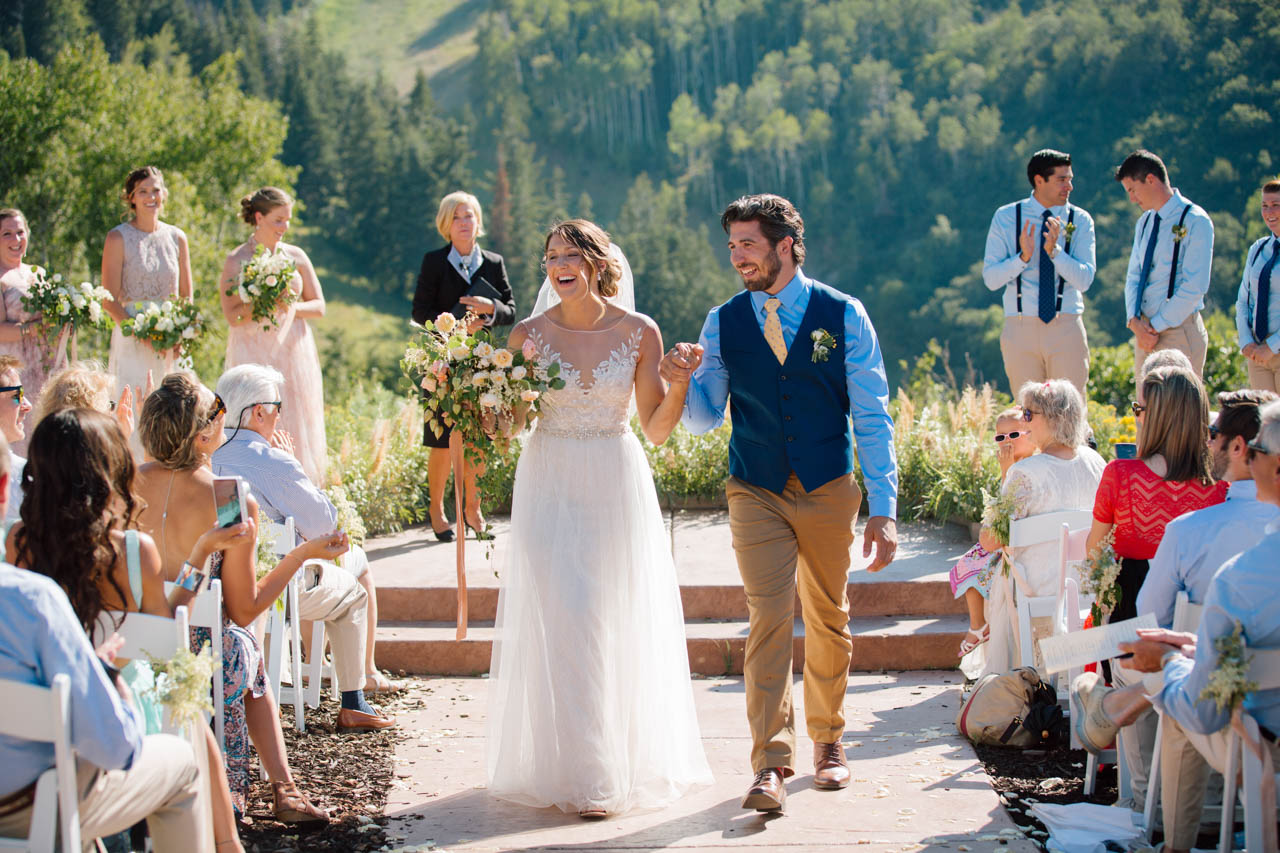 Couple exit after wedding ceremony at Alpine meadows.